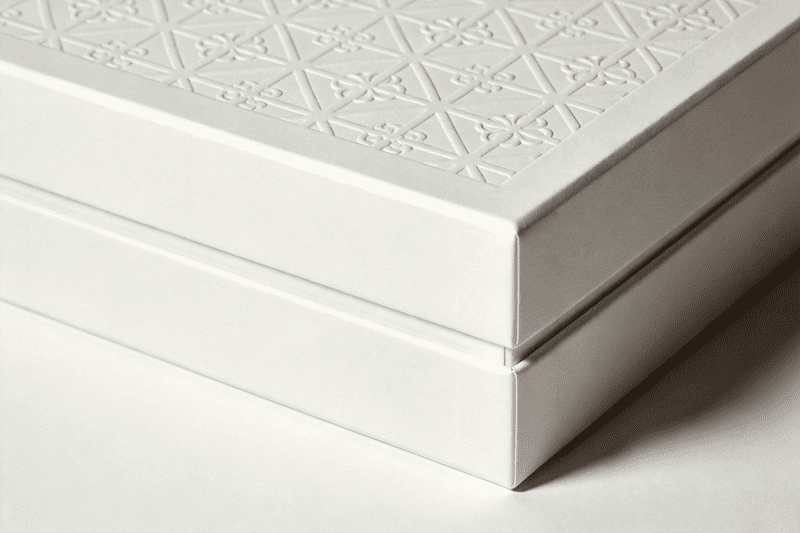 A luxurious, minimalist white box with elegant embossing