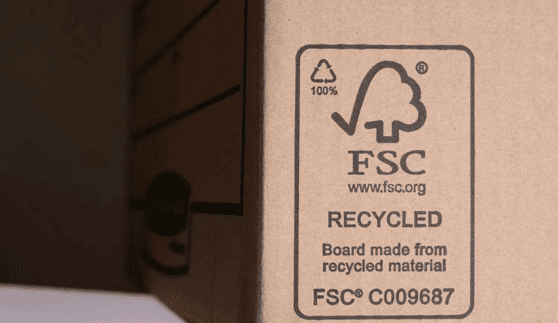 A close-up of the back of a box showing the FSC logo and recycling symbol clearly